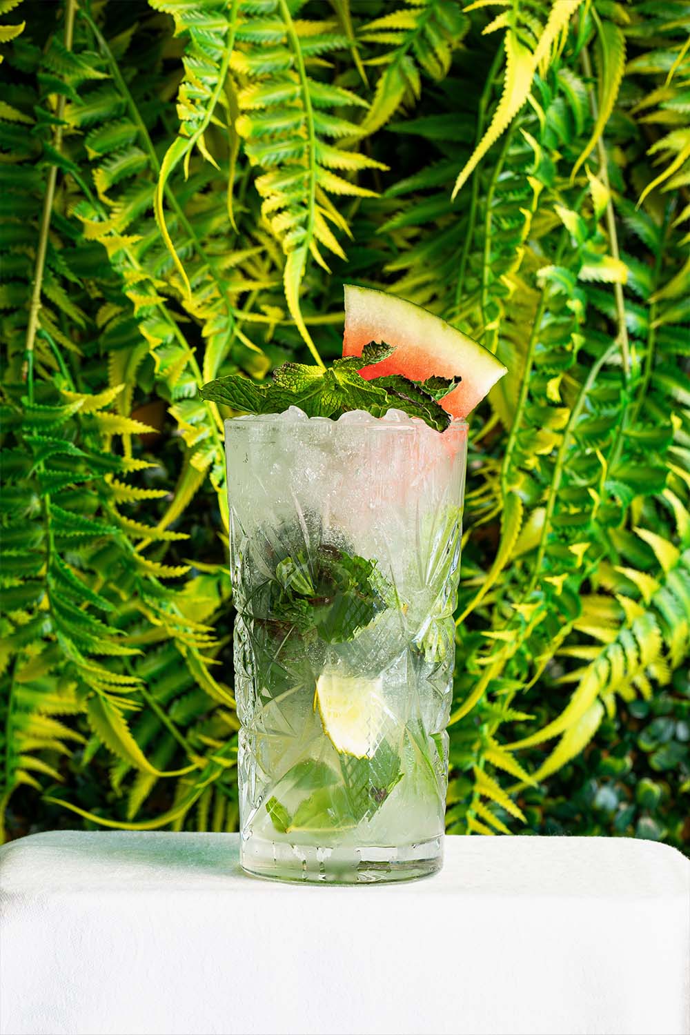 Cóctel frozen de mango decorado con flor, carta de Arena Tropical